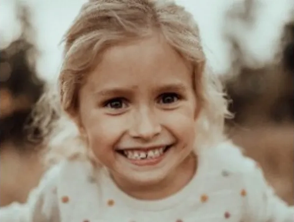 A smiling young girl outdoors